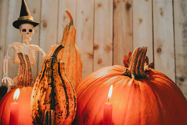 istock Halloween Skeletons Wearing Witch Hats on Pumpkins 2239534999