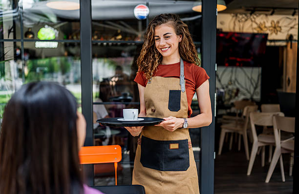 istock Waitress serving coffee to customer at outdoor cafe 2239535224