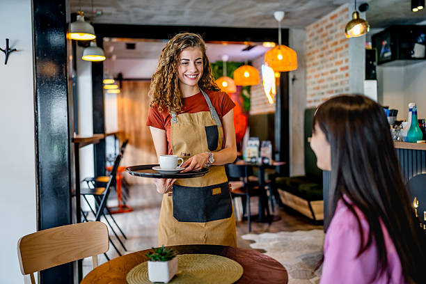 istock Waitress serving coffee to customer in cafe 2239535275