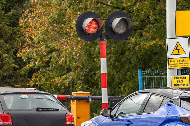 istock Cars waiting at a railway crossing with a passing freight train 2239536994