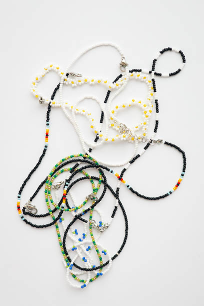 istock Colorful handmade beaded necklaces on white background flat lay. 2239540026