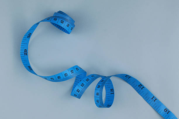 istock Blue measuring tape isolated on blue background 2239541403