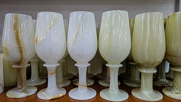 Stylish composition of polished stone vases, cups, and clocks made from marble and onyx. Perfect for modern interiors that value natural textures and timeless elegance