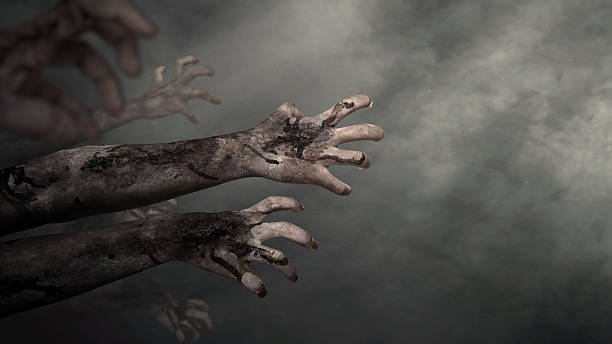 istock Zombie hands with wounds and blood reaching out from a dark background. Zombie, devil, evil, satan, or monster hand. Dramatic smoke or fog effect. Concept of Spooky Halloween 2239544082