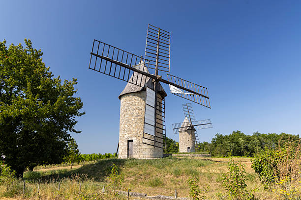 Two old windmills standing on a sunny hill in Montagne, Gironde, France