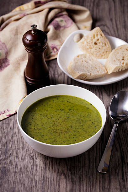 A close-up of a vibrant green lentil and kale soup, perfect for a vegan diet.