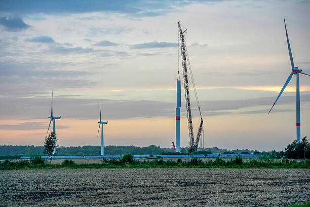 under construction Wind tower turbine power plant at sunset in germany