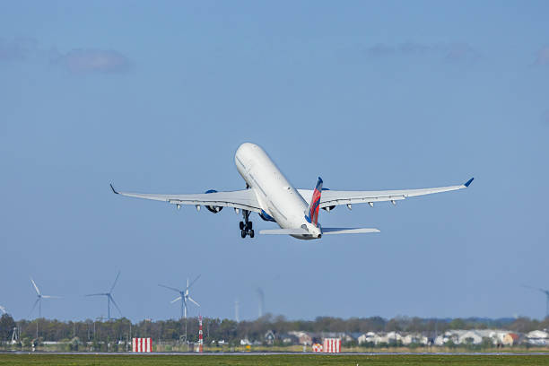 istock Passenger airplane taking off from airport runway on a sunny day 2239549757