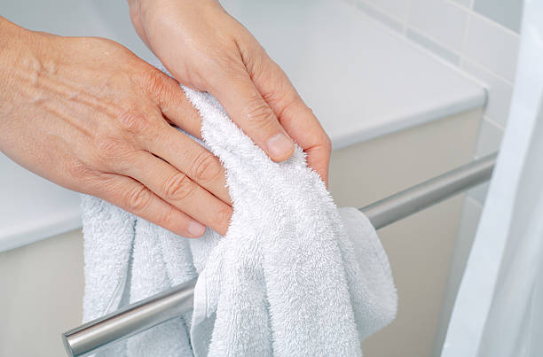 istock a man drying hands with a towel in a bathroom 2239549851
