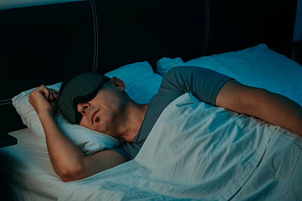 istock a man sleeping with a sleep mask in a bedroom 2239550435
