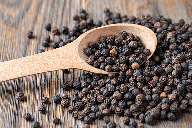 istock black pepper on wooden spoon 2239551197