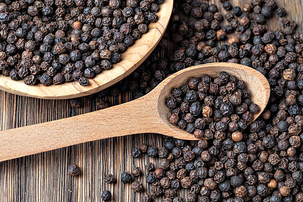 istock black pepper on wooden spoon 2239551199