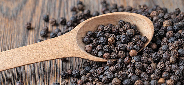 istock black pepper on wooden spoon 2239551203