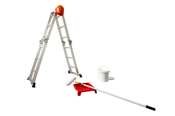Several painting tools and latex paint on a construction site prepared for painting