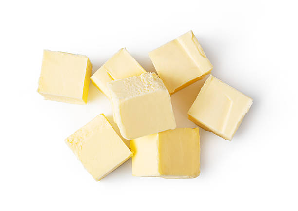 istock Butter block and slices resting on white background 2239554525