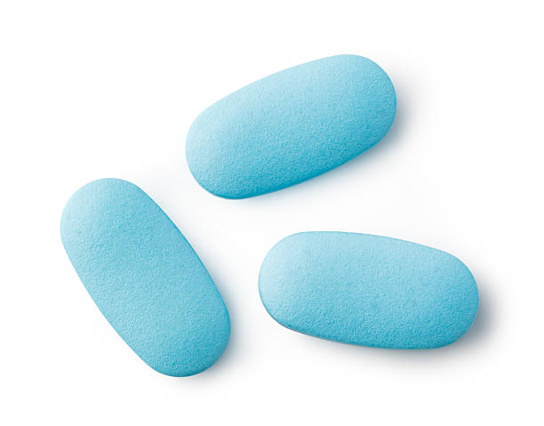 Three light blue medical pills isolated on white background