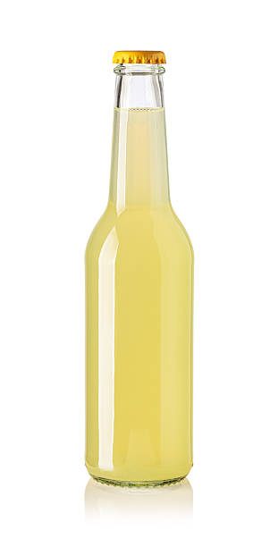 istock Glass bottle containing refreshing lemonade with yellow cap on white background 2239555342