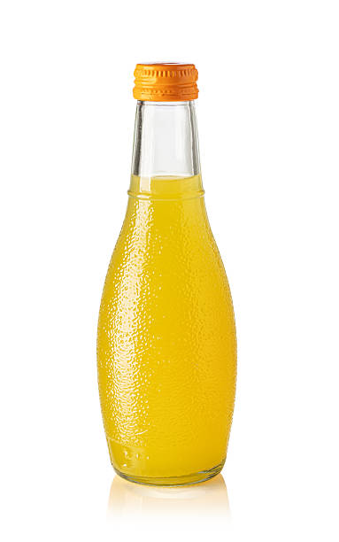 istock Refreshing orange juice in glass bottle with orange cap on white background 2239555355