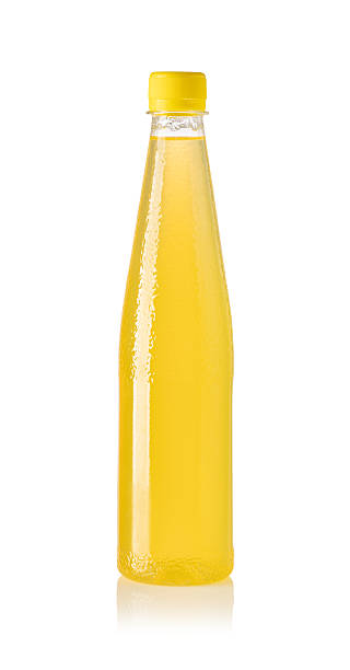 istock Yellow juice or soft drink in plastic bottle with yellow cap on white background 2239555371