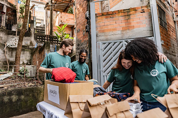 istock Volunteers arranging items for donation outdoors 2239555497