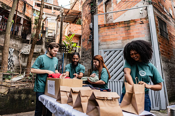 istock Volunteers arranging items for donation outdoors 2239555510