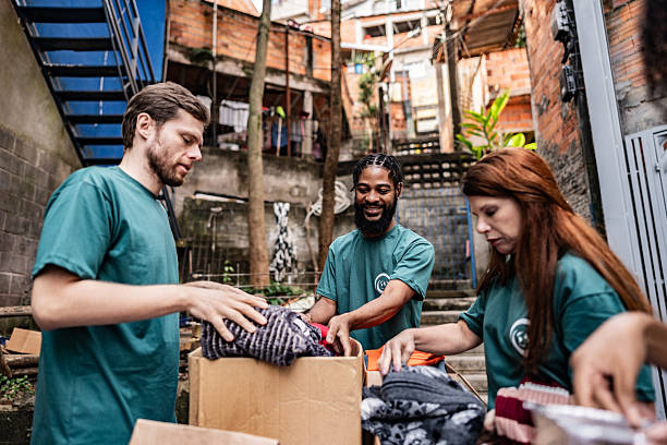 istock Volunteers arranging items for donation outdoors 2239555539