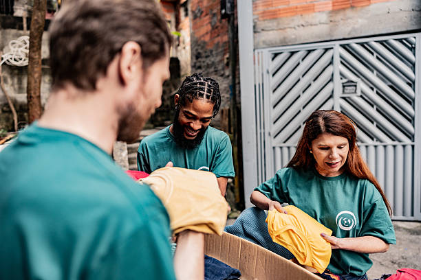 istock Volunteers arranging items for donation outdoors 2239555573