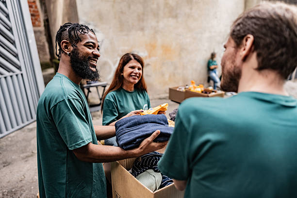 istock Volunteers arranging items for donation outdoors 2239555597