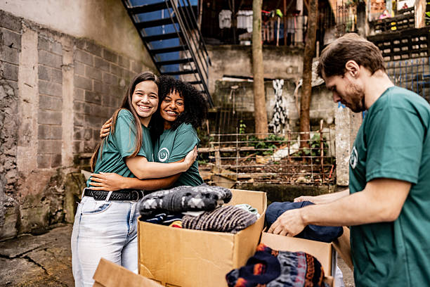 istock Volunteers arranging items for donation outdoors 2239555600