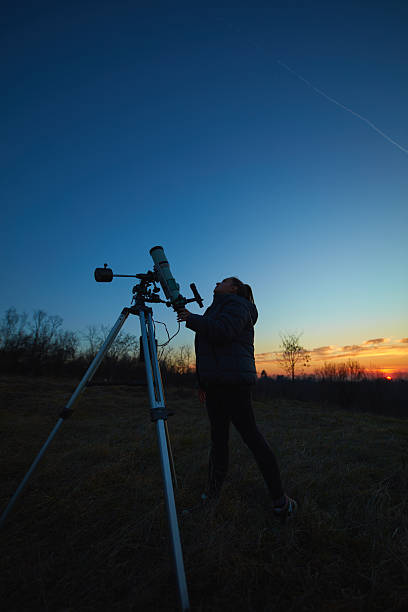 istock Amateur astronomer using telescope for watching stars, Moon, planets and other celestial objects from a field in nature. 2239556197