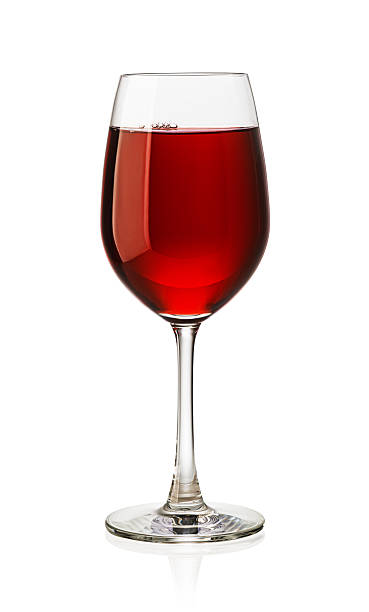 istock Glass of red wine reflecting on white background 2239556557