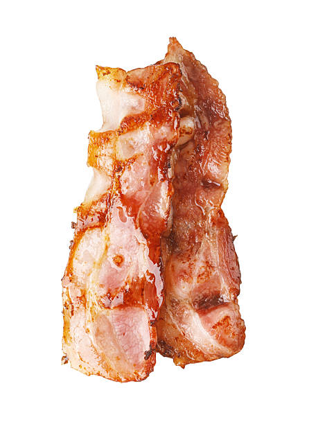 istock Two slices of crispy bacon falling on transparent background 2239556635