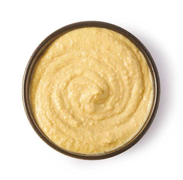 istock Creamy hummus rotating in a bowl: top view close-up 2239556745