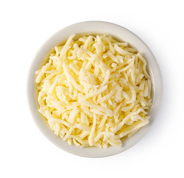 istock Grated cheese overflowing a small bowl on white background 2239556748