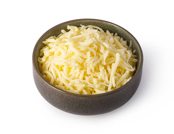 istock Grated cheese overflowing a small bowl on white background 2239556771