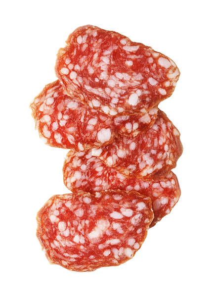 istock Salami slices stacked on white background 2239557297