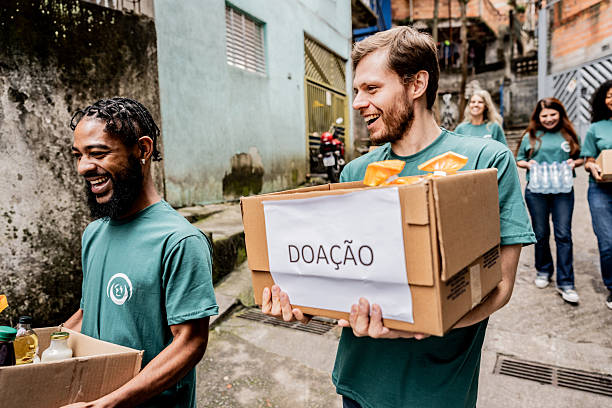 istock Volunteers carrying a donation box outdoors 2239558964