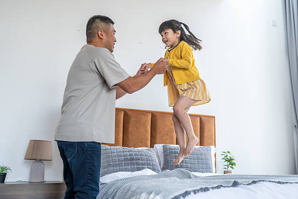 istock Asian Father and Daughter Playing on Bed 2239561848