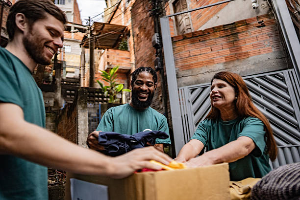 istock Volunteers arranging items for donation outdoors 2239561882