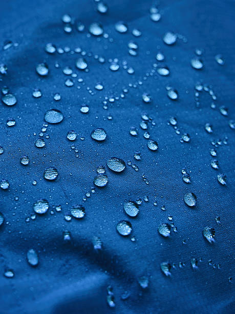 istock Water droplets on blue fiber waterproof fabric. Blue background. 2239563682