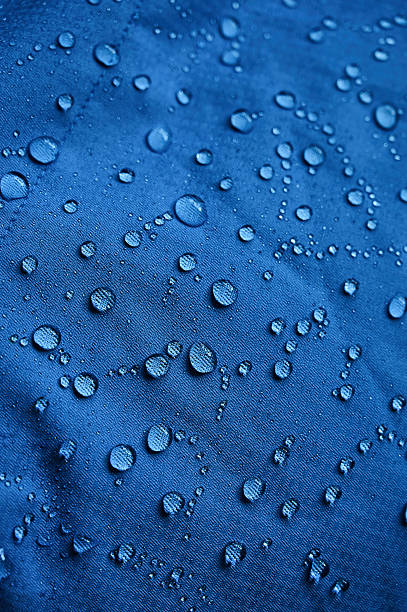istock Water droplets on blue fiber waterproof fabric. Blue background. 2239563693