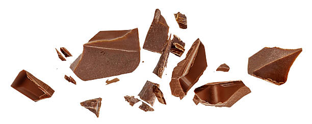istock Broken chocolate bar pieces isolated on white. High-Quality Chocolate chunks with  crumbs Top view. Flat lay. Pattern 2239565577