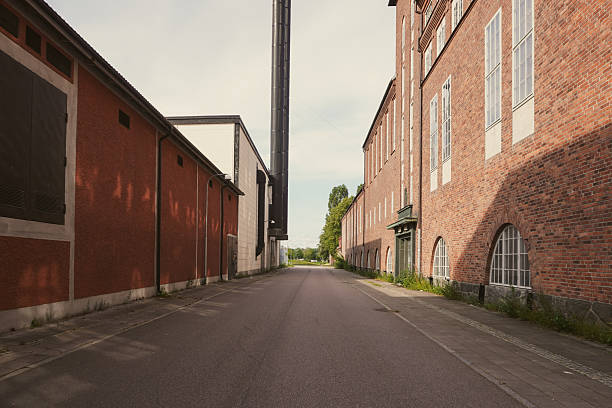 istock An empty street between old industrial buildings 2239565796