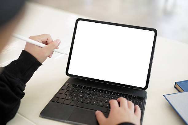 istock A person is using a tablet with a white screen. The tablet is open to a blank page. The person is holding a pen and he is writing on the tablet. 2239566320