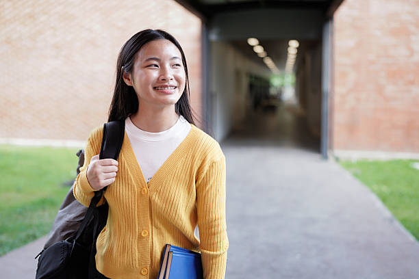 istock Elementary school student walking down a bright school hallway, heading back to class after enjoying recess, carrying a backpack and embracing the joy of learning 2239566412
