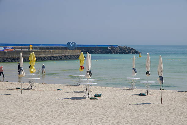Doha, Qatar - April 20, 2022:Locals and tourists enjoying the Persian beaches in Doha, which is famous for its luxury hotel resorts.