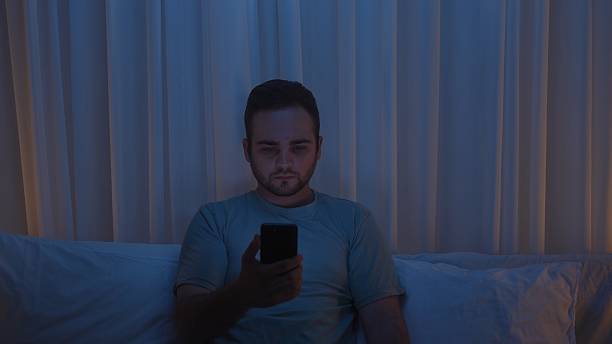 istock A young man uses a smartphone in bed at night 2239569717