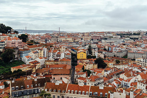 Lisbon, Portugal - October 29, 2022: A cityscape view of the historic Alfama district in Lisbon, Portugal, under an overcast sky a rainy day.