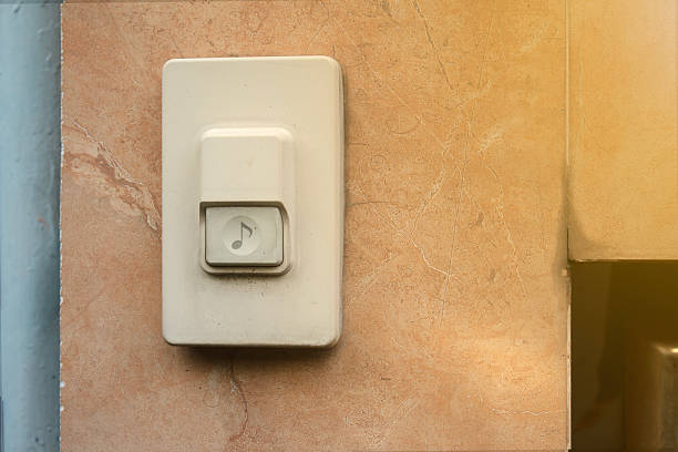 istock Old doorbell button on marble wall with natural sunlight, vintage electric switch concept for home design 2239570271