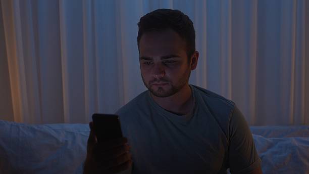 istock A young man uses a smartphone in bed at night 2239570595